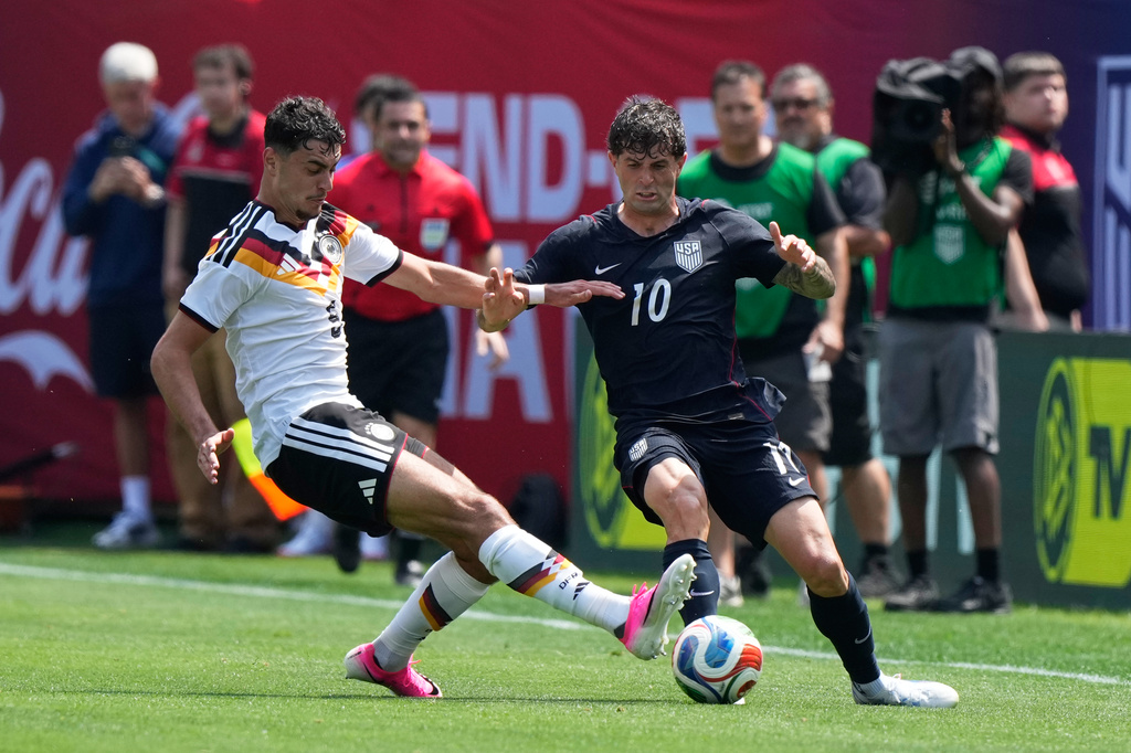 Germany midfielder Aleksandar Pavlović, left, tackles the ball from United States forward Christian Pulisic during the first half of an international friendly soccer match in Chicago, Saturday, June 6, 2026. (AP Photo/Nam Y. Huh)
