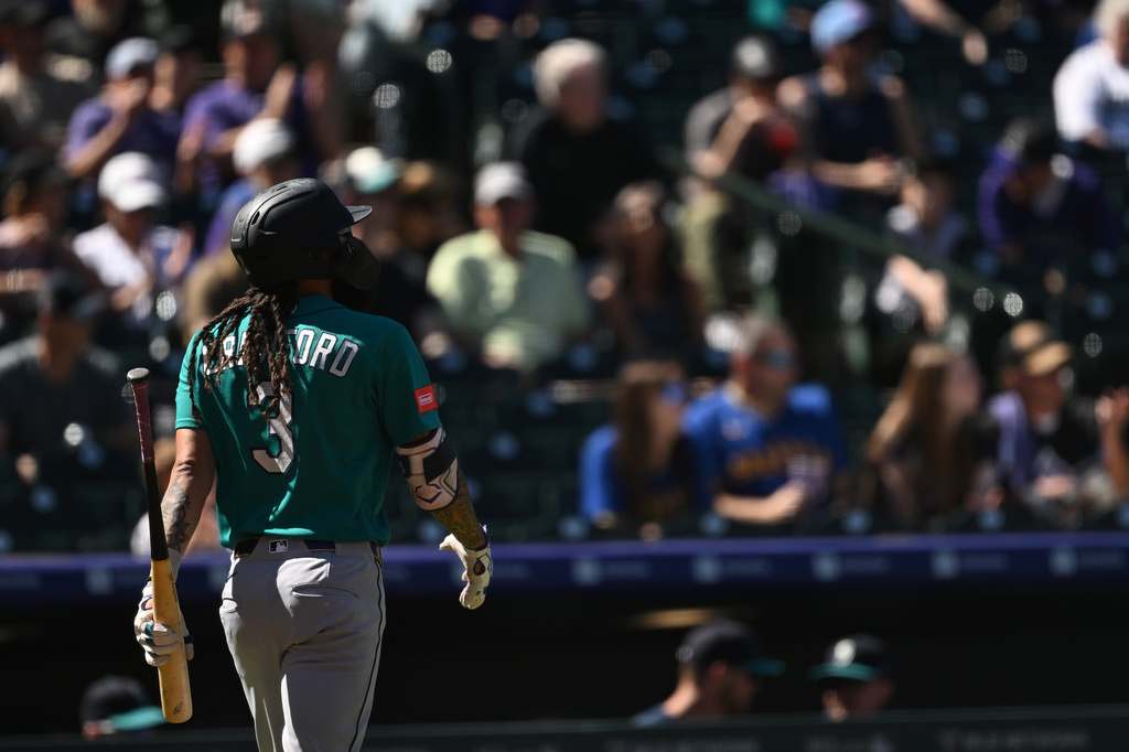 Seattle Mariners shortstop J.P. Crawford walks back to the dugout after striking out in the first inning against the Colorado Rockies during a baseball game Sunday, Sept. 20, 2026, in Denver. (AP Photo/RJ Sangosti)
