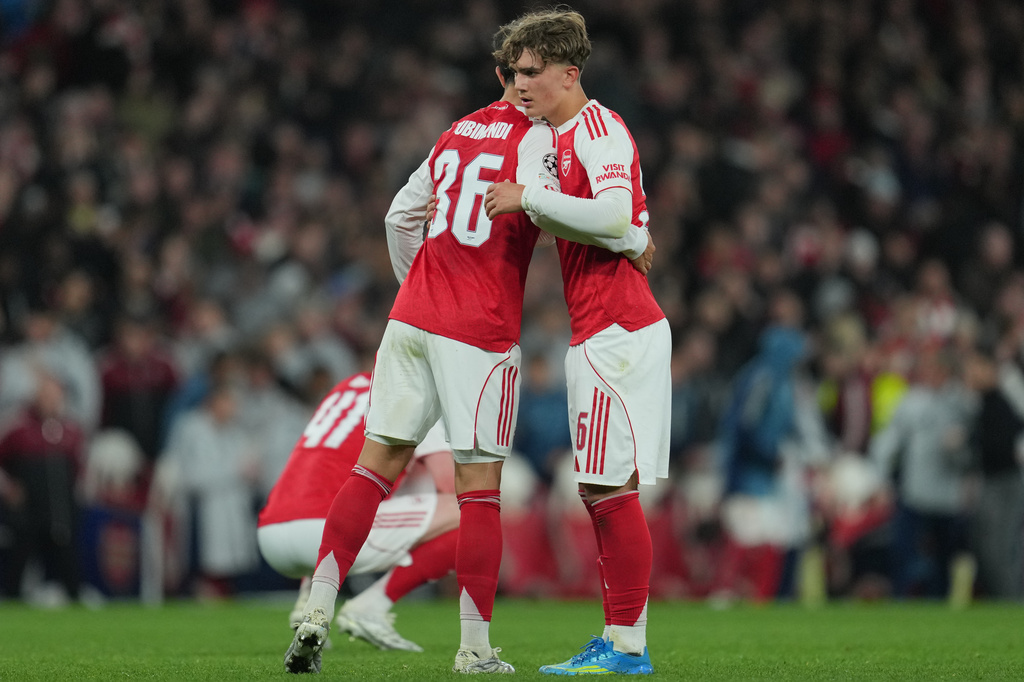 Arsenal's Martin Zubimendi, left, and Max Dowman hug afterthe UEFA Champions League second leg quarterfinal soccer match between Arsenal and Sporting in London, England, Wednesday, April 15, 2026. (AP Photo/Kin Cheung)