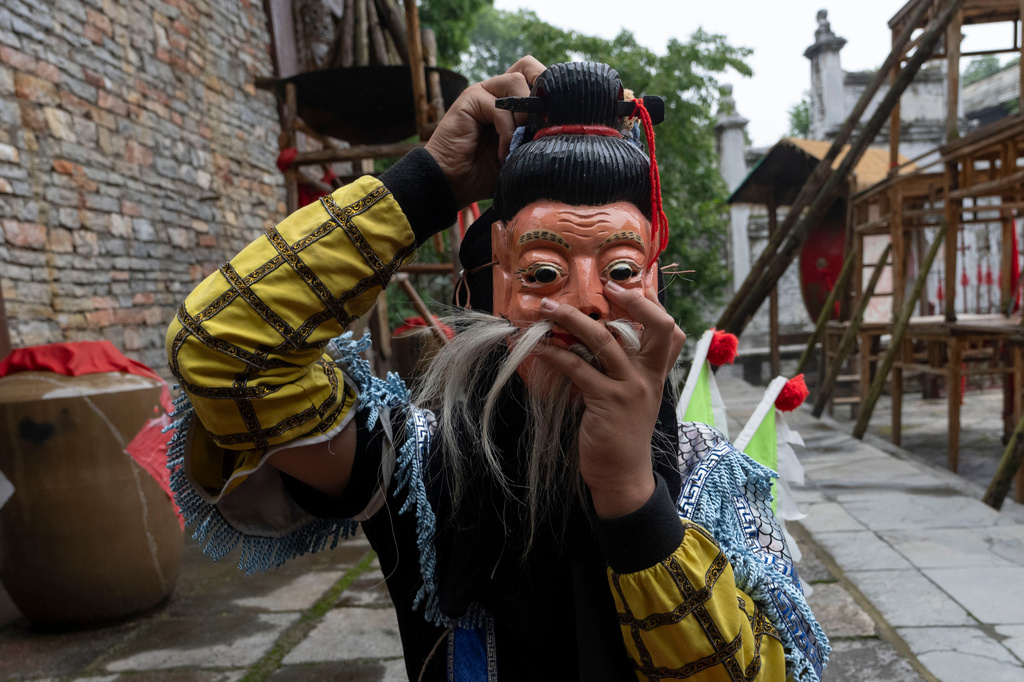 A Dixi opera performer prepares for a show at Tianlong Tunpu, an ancient town in southwestern China's Guizhou province on Thursday, May 28, 2026. (AP Photo/Ng Han Guan)