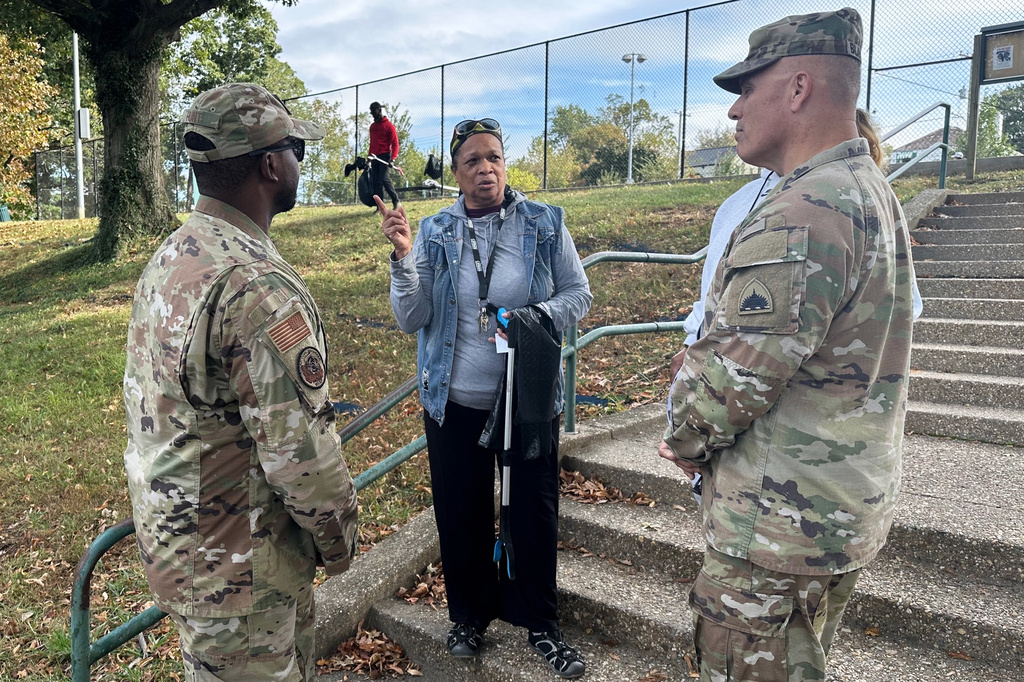 Neighborhood resident and volunteer, Valencia Mohammed, center, talks to D.C. National Guard interim commander Army Brig. Gen. Leland Blanchard II, right, and Lt. Col. Marcus Hunt, left, about cleanup efforts at Fort Stevens Recreation Center, Saturday, Oct. 11, 2025, in Washington. Mohammed requested the cleanup. Marcus Hickman, Anacostia ANC Commisioner, is seen rear. (AP Photo/Gary Fields)