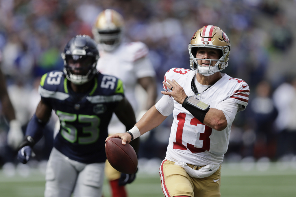 San Francisco 49ers quarterback Brock Purdy (13) runs the ball during the first half of an NFL football game against the Seattle Seahawks, Sunday, Sept. 7, 2025, in Seattle. (AP Photo/John Froschauer)