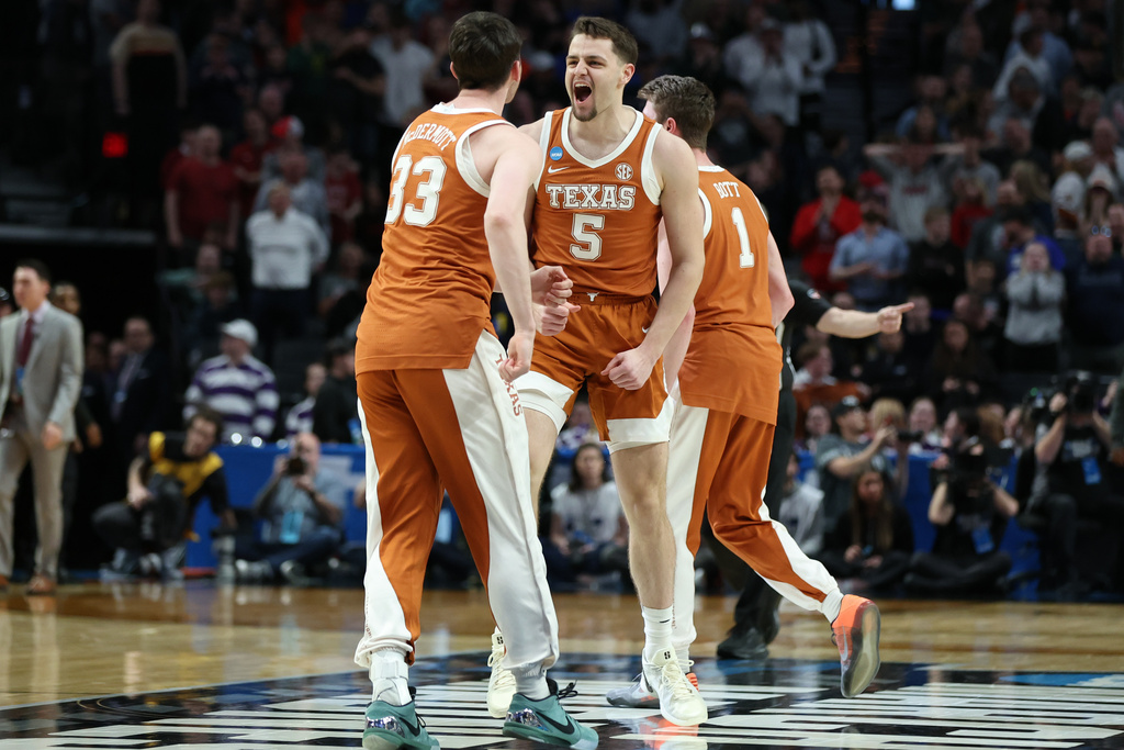 Texas forward Camden Heide (5) celebrates with teammates after the second round of the NCAA college basketball tournament against Gonzaga, Saturday, March 21, 2026, in Portland, Ore. (AP Photo/Amanda Loman)