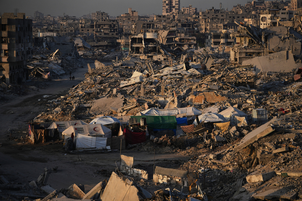 Tents for displaced Palestinians stand amid the destruction caused by the Israeli air and ground offensive in Sheikh Radwan neighborhood in Gaza City, Wednesday, Oct. 22, 2025. (AP Photo/Abdel Kareem Hana)