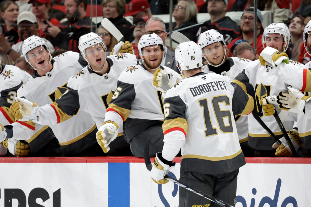 Vegas Golden Knights right wing Pavel Dorofeyev (16) celebrates his goal with teammates after he scored against the Carolina Hurricanes during the first period of an NHL hockey game Tuesday, Oct. 28, 2025, in Raleigh, N.C. (AP Photo/Chris Seward)