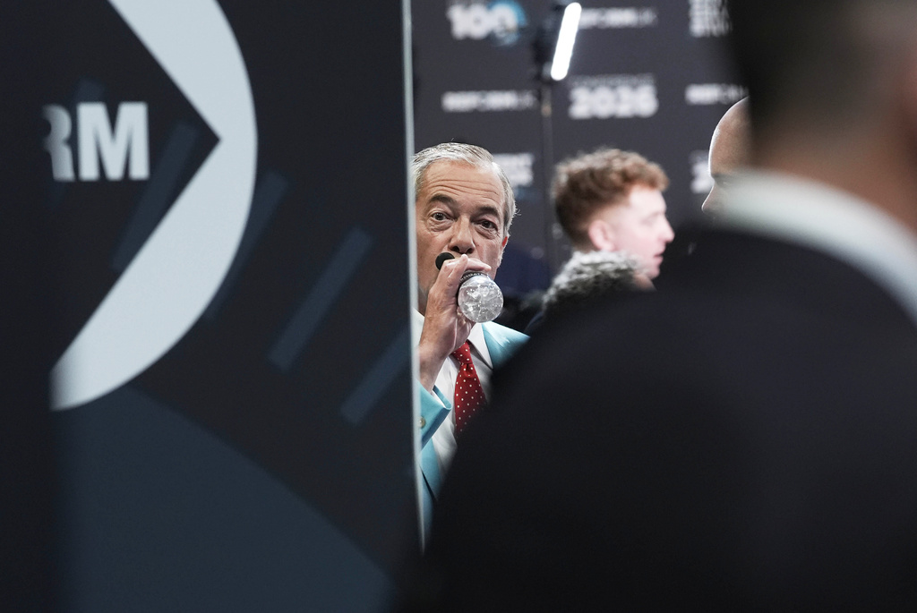 Reform UK leader Nigel Farage drinks water, during the Reform party's annual conference, in Birmingham, England, Saturday, Sept. 5, 2026. (Stefan Rousseau/PA via AP)