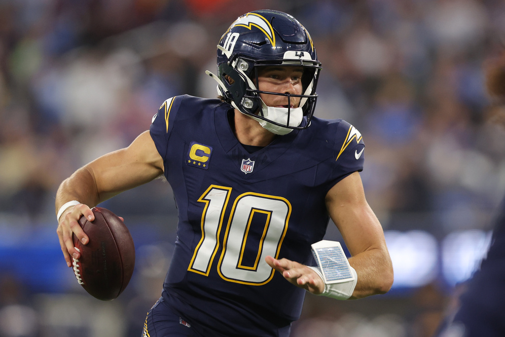 Los Angeles Chargers quarterback Justin Herbert (10) runs with the football during the first half of an NFL football game against the Minnesota Vikings Thursday, Oct. 23, 2025, in Inglewood, Calif. (AP Photo/Jessie Alcheh)