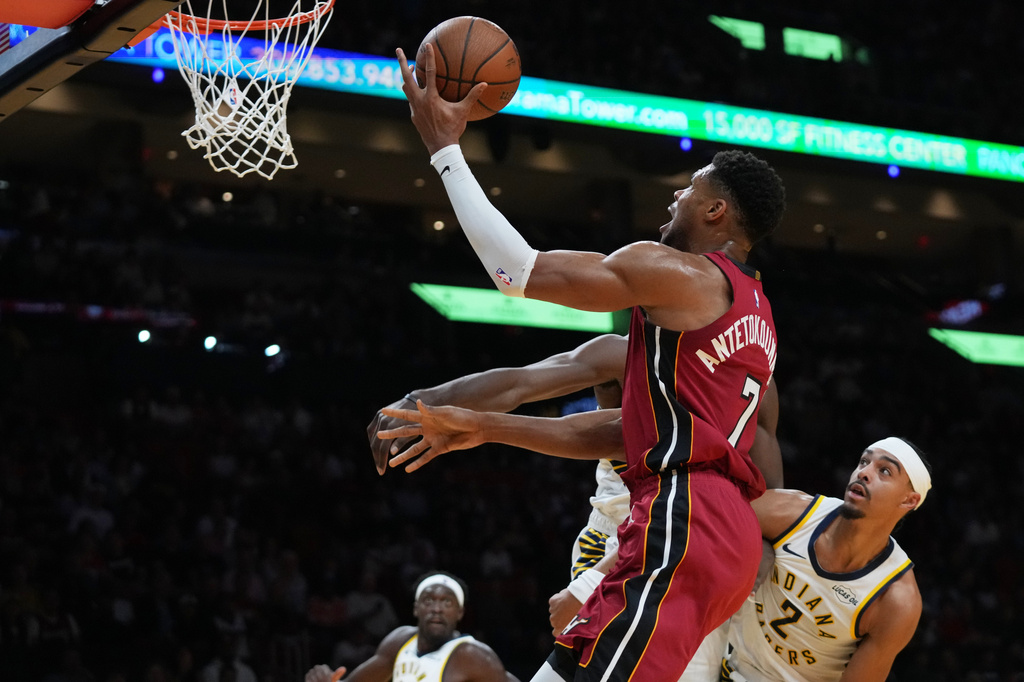 Miami Heat forward Giannis Antetokounmpo (7) goes to the basket as Indiana Pacers guard Andrew Nembhard (2) defends during the first half of an NBA Cup basketball game, Friday, Oct. 30, 2026, in Miami. (AP Photo/Lynne Sladky)