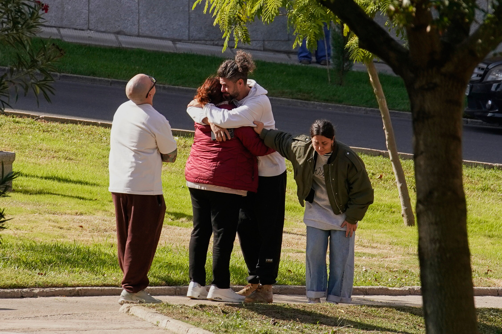 People searching for relatives who were traveling on the trains involved in a collision gather at a religious residence converted into a temporary medical facility in Toledo, Spain, Thursday, Oct. 29, 2026. (AP Photo/Andrea Comas)