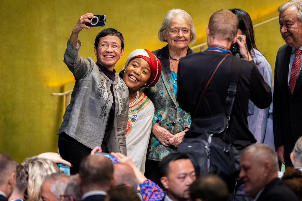 Maria Ressa, a Nobel Peace Prize-winning journalist, and Maryam Bukar, Global Advocate for Peace, take a selfie together after they each addressed the 80th session of the United Nations General Assembly (UNGA) at United Nations headquarters, Monday, Sept. 22, 2025. (AP Photo/Angelina Katsanis)