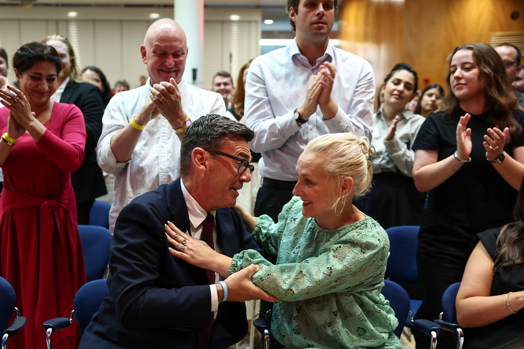 Andy Burnham hugs his wife Marie-France van Heel as he is confirmed as the Labour Party's new leader and the country's next prime minister, during 'Labour's Special Conference' in central London, Friday July 17, 2026. (Henry Nicholls/Pool Photo via AP)