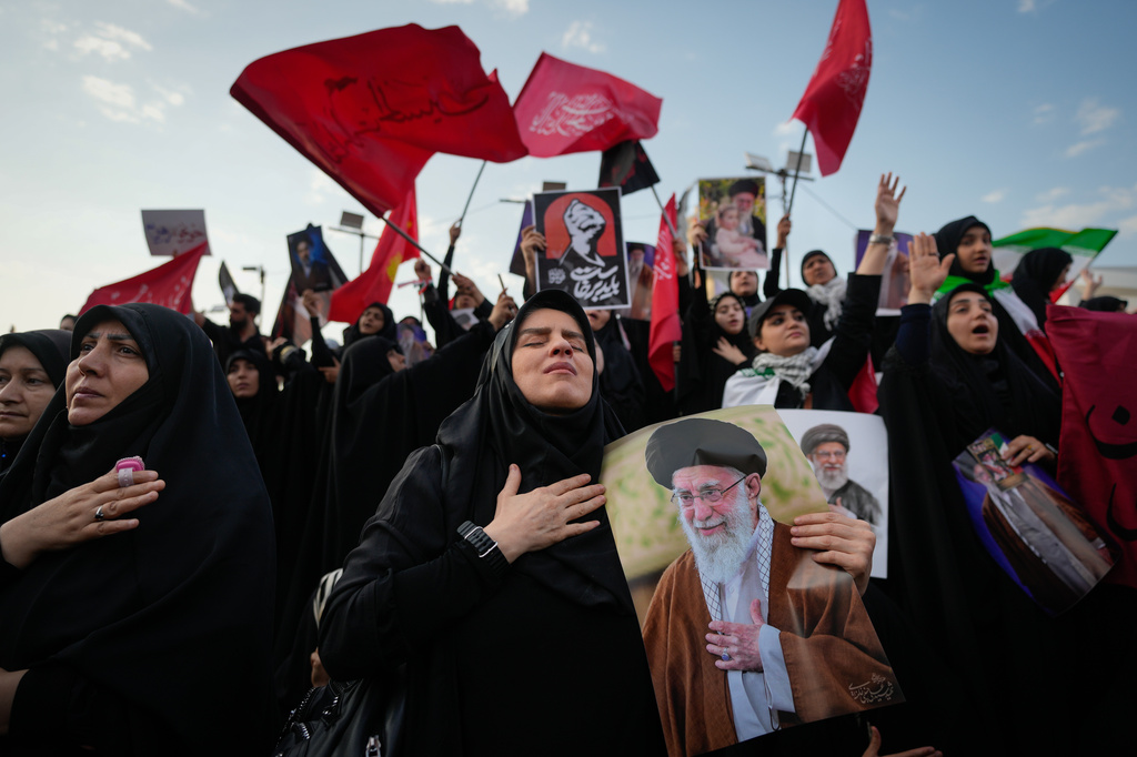 A mourner reacts while holding a portrait of the slain Iranian Supreme Leader Ayatollah Ali Khamenei as mourners gather in Islamic Revolution Square for Khamenei's funeral procession in Tehran, Iran, Monday, July 6, 2026. (AP Photo/Altaf Qadri)
