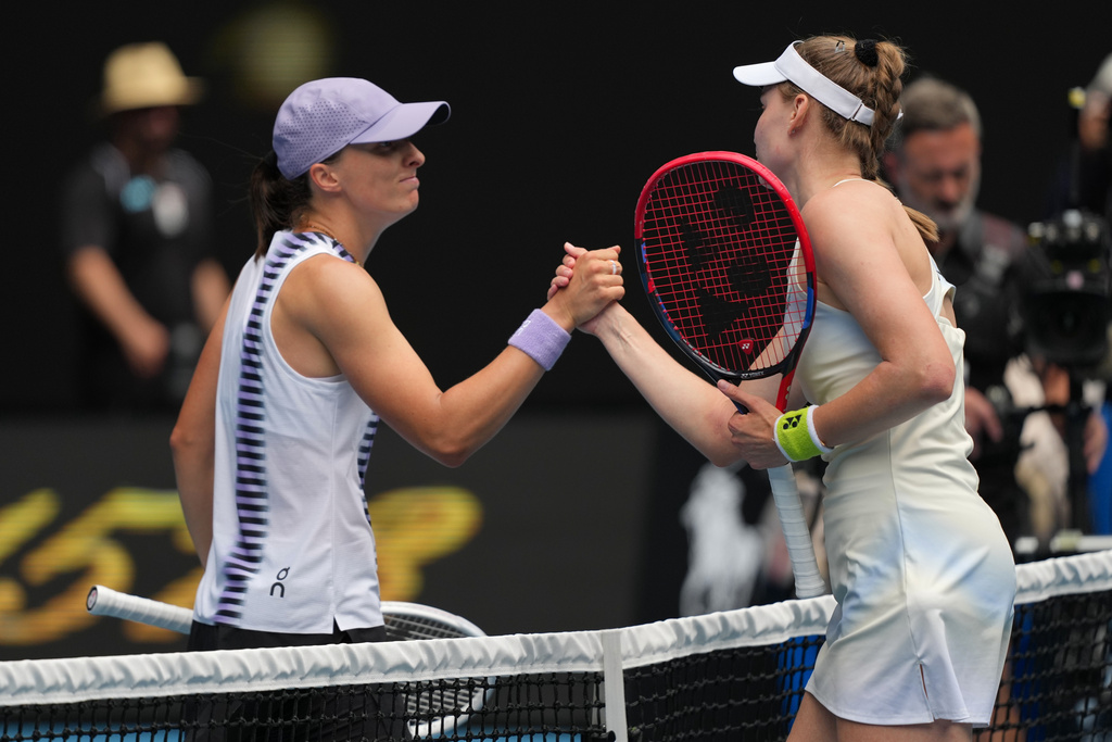 Elena Rybakina, right, of Kazakhstan is congratulated by Iga Swiatek of Poland following their quarterfinal match at the Australian Open tennis championship in Melbourne, Australia, Wednesday, Jan. 28, 2026. (AP Photo/Dar Yasin)