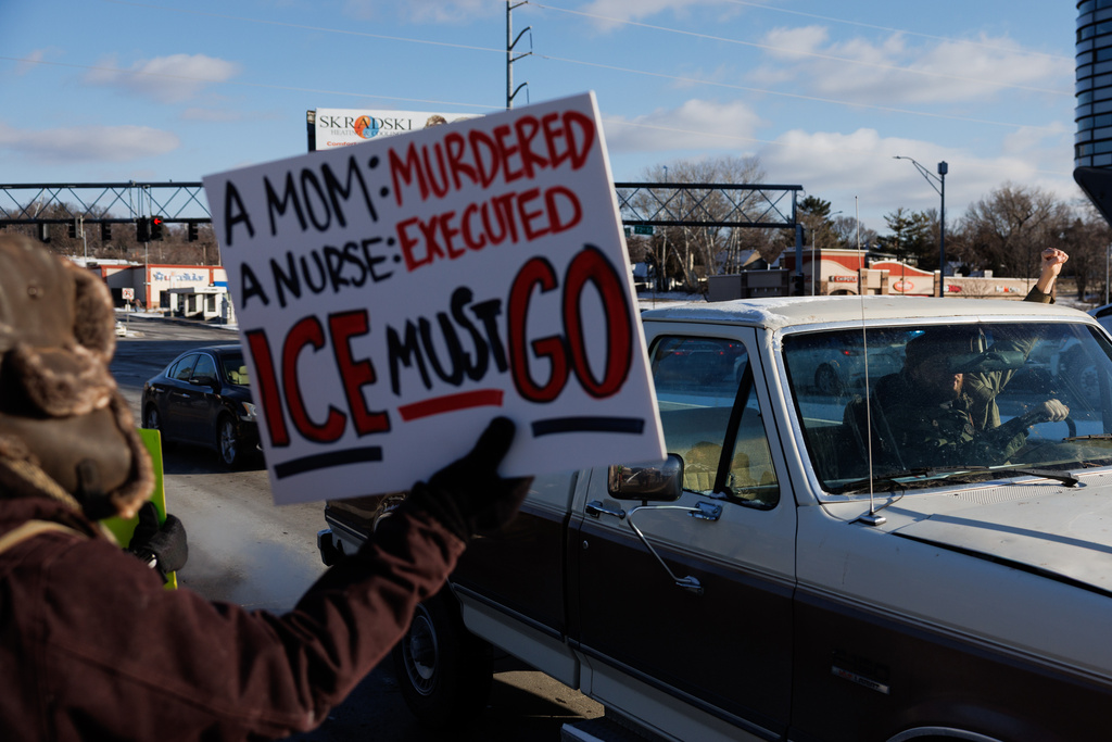 People protest against ICE (Immigration and Customs Enforcement) in Omaha, Neb. on Sunday, Jan. 25, 2026. (Nikos Frazier/Omaha World-Herald via AP)