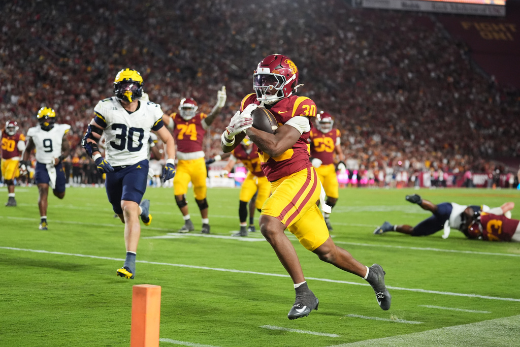 Southern California running back King Miller (30) scores a rushing touchdown during the second half of an NCAA college football game against Michigan, Saturday, Oct. 11, 2025, in Los Angeles. (AP Photo/Marcio Jose Sanchez)