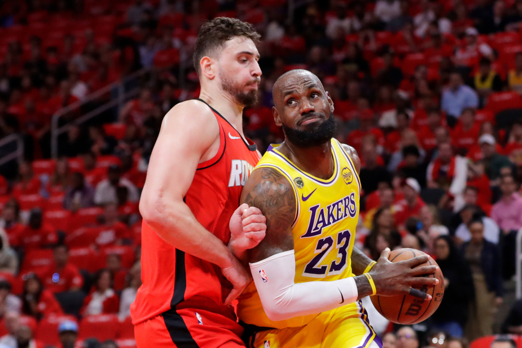 Los Angeles Lakers forward LeBron James (23) drives to the basket in front of Houston Rockets center Alperen Sengun, left, during the first half of Game 3 in a first-round NBA playoffs basketball series Friday April 24, 2026, in Houston. (AP Photo/Michael Wyke)