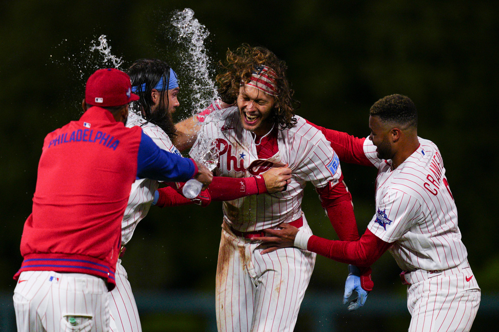 Philadelphia Phillies' Alec Bohm, secind from right, celebrates with teammates after his walkoff sacrifice fly during the 10th inning of the second baseball game of a doubleheader against the San Francisco Giants, Thursday, April 30, 2026, in Philadelphia. (AP Photo/Derik Hamilton)