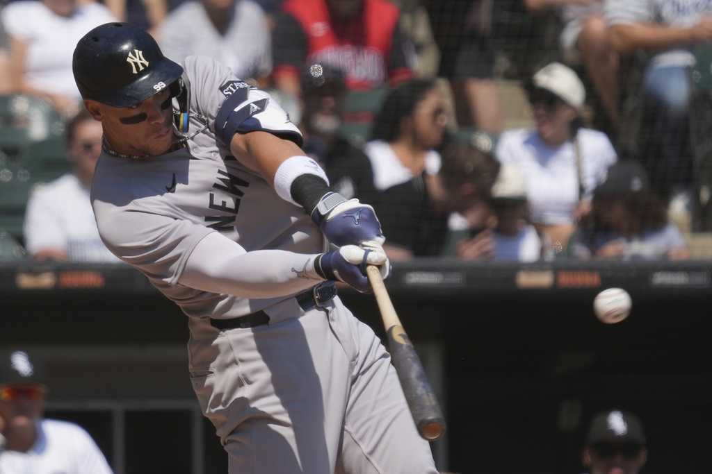 New York Yankees' Aaron Judge hits a solo home run during the first inning of a baseball game against the Chicago White Sox in Chicago, Sunday, Aug. 31, 2025. (AP Photo/Nam Y. Huh)
