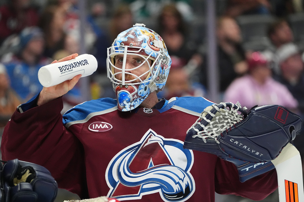Colorado Avalanche goaltender Scott Wedgewood takes a drink during a break in the action in the second period of an NHL hockey game against the Tampa Bay Lightning Tuesday, Nov. 4, 2025, in Denver. (AP Photo/David Zalubowski)