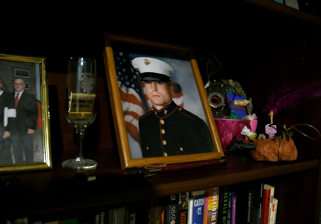 Joe Shearer, who was recently diagnosed with traumatic brain injuries from fighting in Iraq, is seen in his Marine Corps portrait displayed in his home in Colorado Springs, Colo., Wednesday, Aug. 5, 2026. (AP Photo/Thomas Peipert)