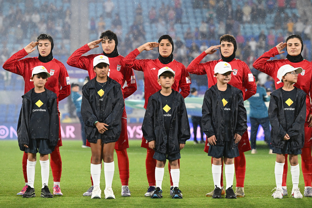 Iran players react during their national anthem ahead of the Women's Asian Cup soccer match between Iran and the Philippines in Robina, Australia, Sunday, March 8, 2026. (Dave Hunt/AAP Image via AP)