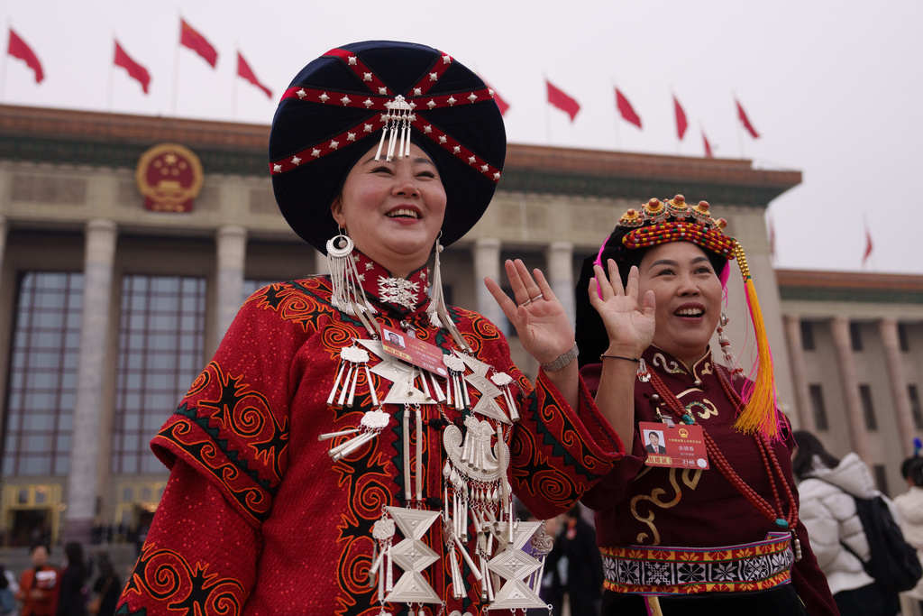 Ethnic minority delegates wave as they leave after the opening session of the National People's Congress (NPC) at the Great Hall of the People in Beijing, China, Thursday, March 5, 2026. (AP Photo/Vincent Thian)