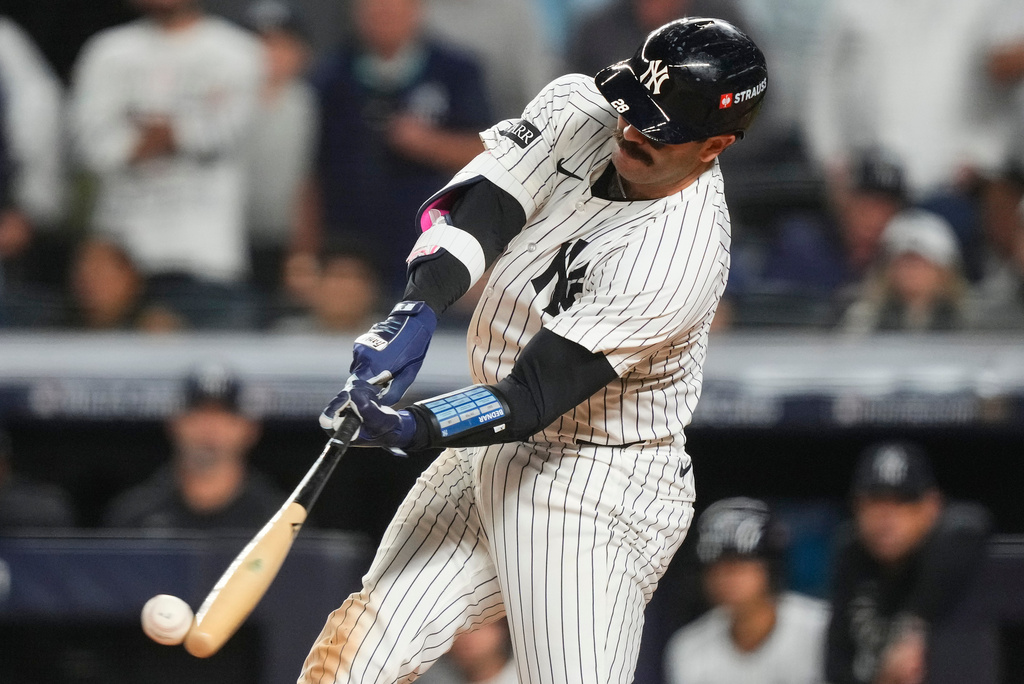 New York Yankees catcher Austin Wells (28) connects for an RBI single to right field to drive in Jazz Chisholm Jr. against the Boston Red Sox during the eighth inning of Game 2 of an American League wild-card baseball playoff series, Wednesday, Oct. 1, 2025, in New York. (AP Photo/Yuki Iwamura)