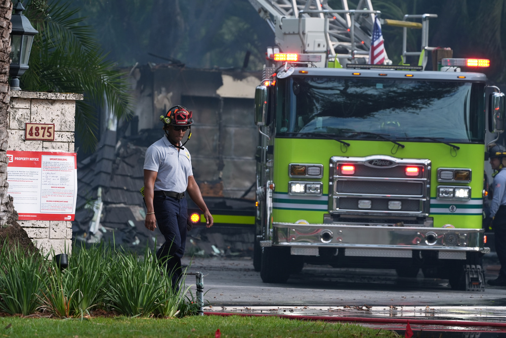 Firefighters work to extinguish the remains of a fire at a home owned by Miami Heat basketball coach Erik Spoelstra, Thursday, Nov. 6, 2025, in Miami. (AP Photo/Rebecca Blackwell)