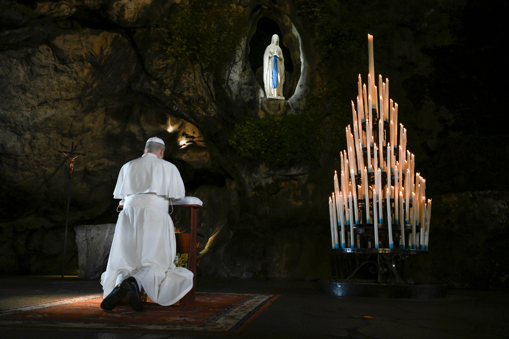 In this handout photo provided by Vatican Media Pope Leo XIV prays at the Grotto of the Apparitions of Massabielle, in Lourdes, France, Saturday, Sept. 26, 2026. (Vatican Media via AP)