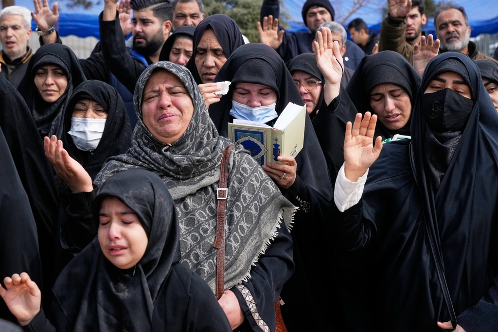 Mourners pray during the funeral of Mehdi Hosseini, a man killed in a U.S.-Israeli strike, at Behesht-e Zahra cemetery in Tehran, Iran, Monday, March 9, 2026. (AP Photo/Vahid Salemi)
