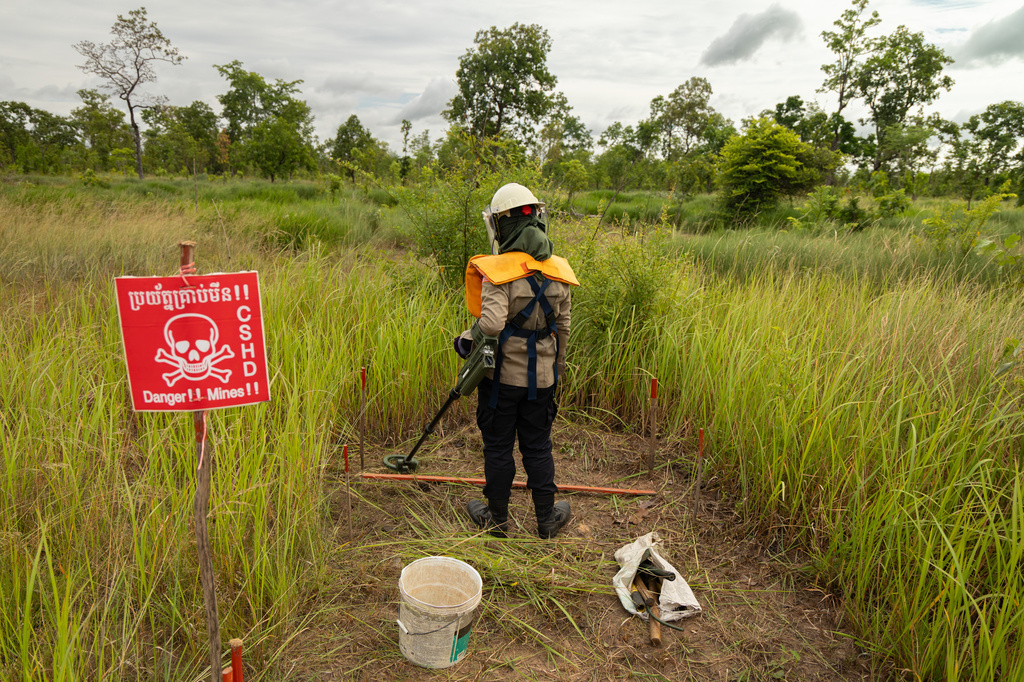 A deminer uses a metal detector to clear a landmine field in Siem Reap, Cambodia, Thursday, July 2, 2026. (AP Photo/Anton L. Delgado)