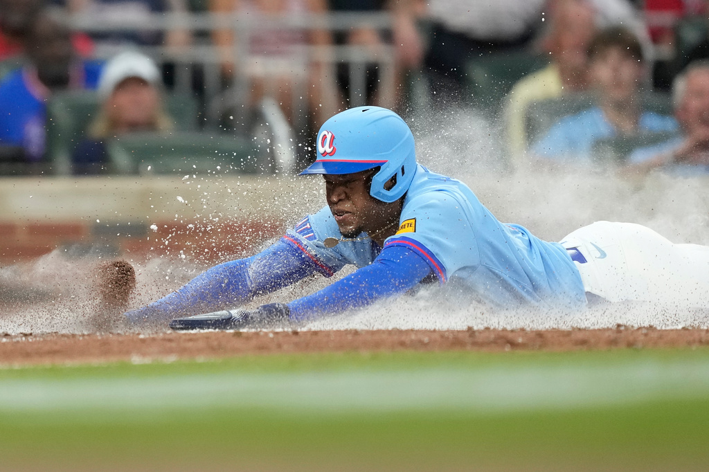 Atlanta Braves' José Azócar slides into home in the fifth inning of a baseball game against the Boston Red Sox Saturday, May 16, 2026, in Atlanta. (AP Photo/Brynn Anderson)