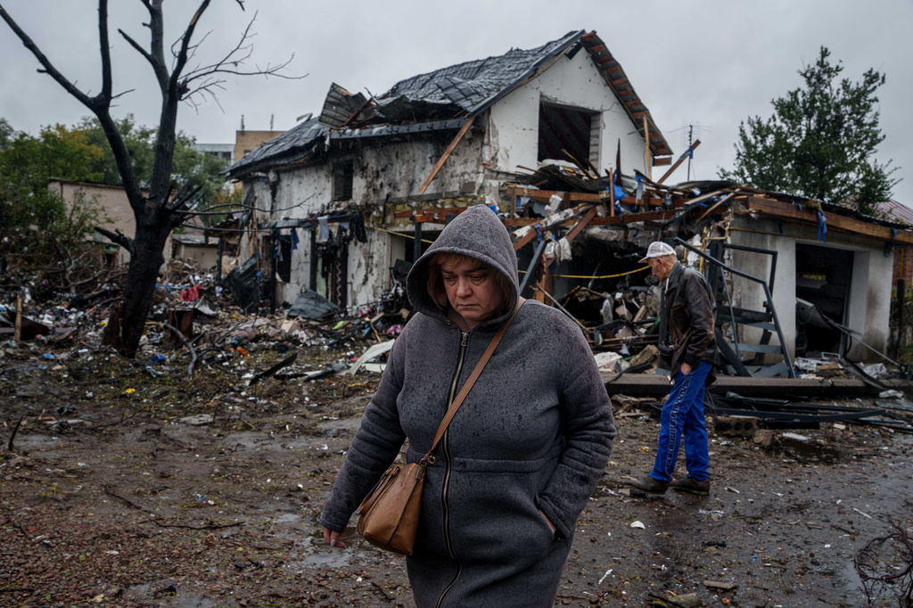 A woman walks in front of a house that was heavily damaged in a Russian strike on a residential neighbourhood in Kyiv, Ukraine, Thursday, Sept. 24, 2026. (AP Photo/Evgeniy Maloletka)