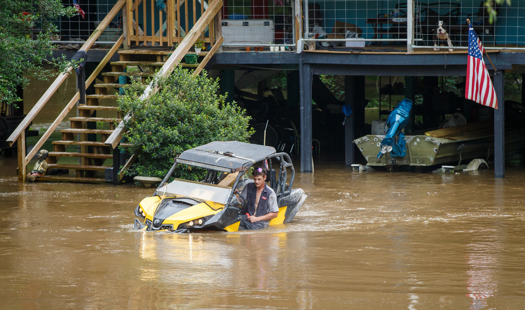 Dalton Saacks moves a mud buggy from the rising Tchefuncte River ahead of Tropical Storm Arthur near Folsom, La., Wednesday, June 17, 2026. (David Grunfeld/The Times-Picayune/The New Orleans Advocate via AP)