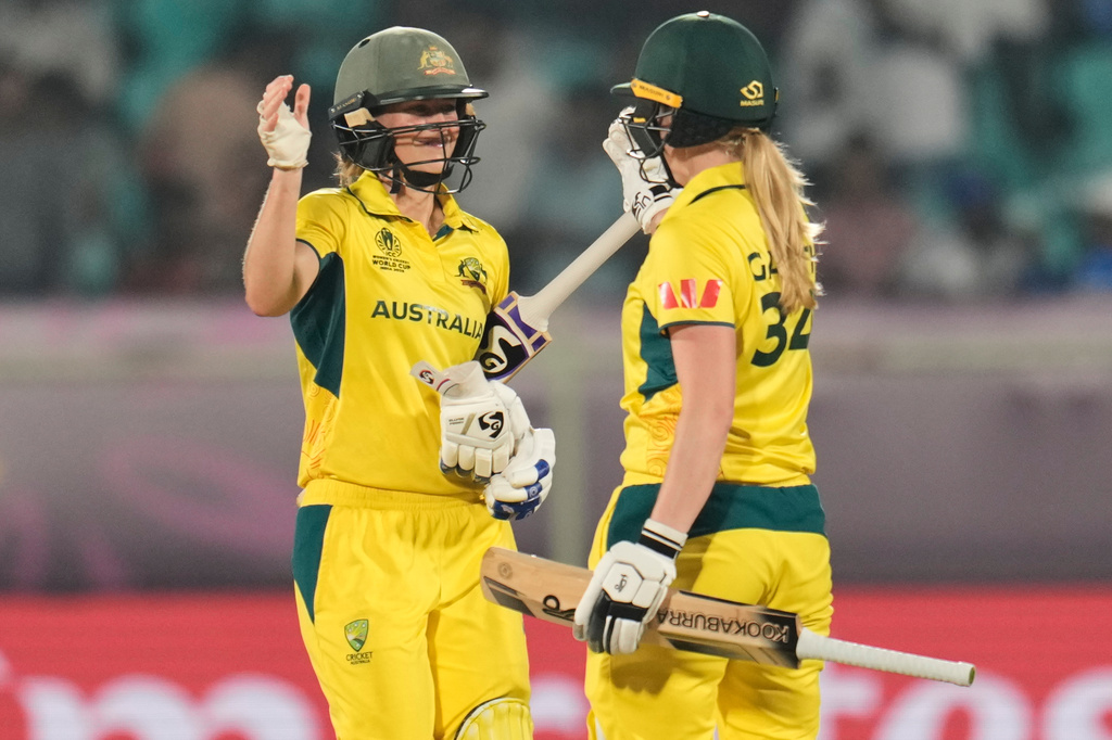 Australia's Ellyse Perry, left, and batting partner Kim Garth celebrate after their win in the ICC Women's Cricket World Cup match against India at ACA-VDCA Cricket Stadium in Visakhapatnam, India, Sunday, Oct. 12, 2025. (AP Photo/Aijaz Rahi)