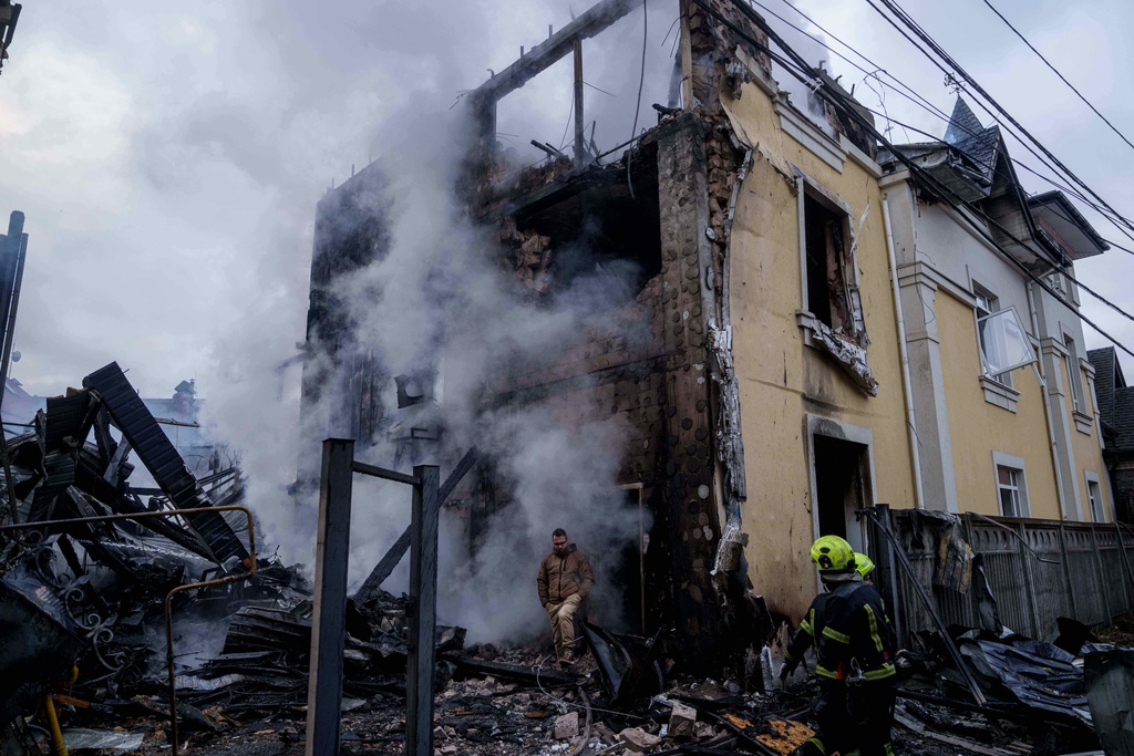 A man walks from a house destroyed after a Russian strike on Kyiv, Ukraine, on Saturday, Dec. 27, 2025. (AP Photo/Evgeniy Maloletka)