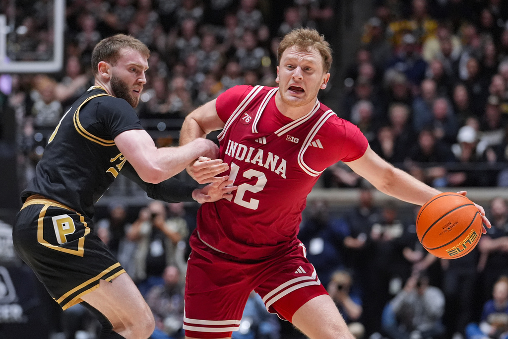 Purdue guard Braden Smith (3) fouls Indiana forward Tucker Devries (12) during the first half of an NCAA college basketball game in West Lafayette, Ind., Friday, Feb. 20, 2026. (AP Photo/Michael Conroy)