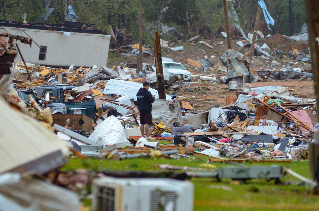 A man looks at the destruction left at Gene’s Mobile Home Supply, a trailer park in Bogue Chitto, Miss., on Thursday, May 7, 2026, after a tornado cut across the state. (Matt WIlliamson/Enterprise-Journal via AP)