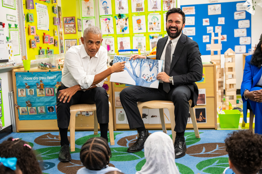 Former President Barack Obama, left, and Mayor Zohran Mamdani read a book to children at Learning Through Play Pre-K in New York, on Saturday, April 18, 2026. (AP Photo/Angelina Katsanis)