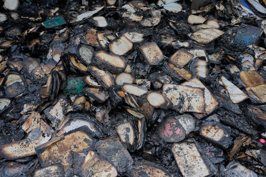 Burned books are seen after the fire on the site of the country's biggest book market, cased by Russia's recent missile attack in Kyiv, Ukraine, Wednesday, Aug.19, 2026. (AP Photo/Efrem Lukatsky)