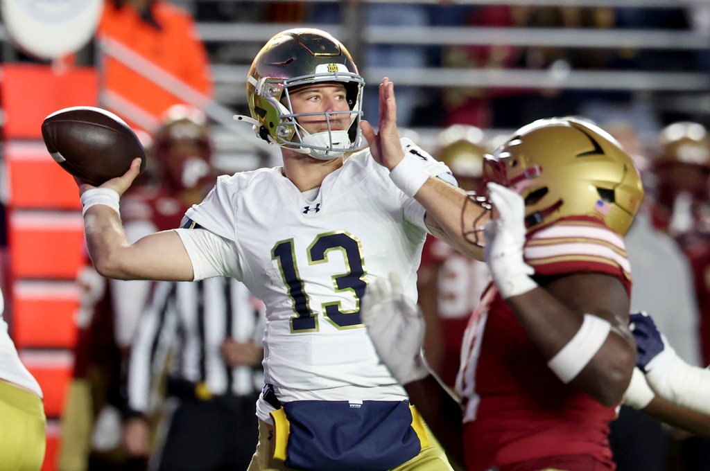 Notre Dame quarterback CJ Carr (13) eyes a receiver during the second half of an NCAA college football game against Boston College, Saturday, Nov. 1, 2025 in Boston. (AP Photo/Mark Stockwell)