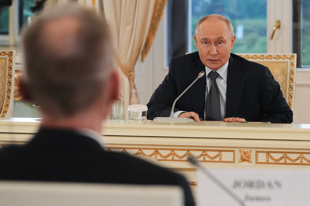 Russian President Vladimir Putin, foreground answers to a question by The Associated Press News Director of Europe/Africa James Jordan, back to a camera as he meets with representatives of international news agencies on the sidelines of the St. Petersburg International Economic Forum at the Constantine Palace in St. Petersburg, Russia, on Thursday, June 4, 2026. (AP Photo/Dmitri Lovetsky, Pool)