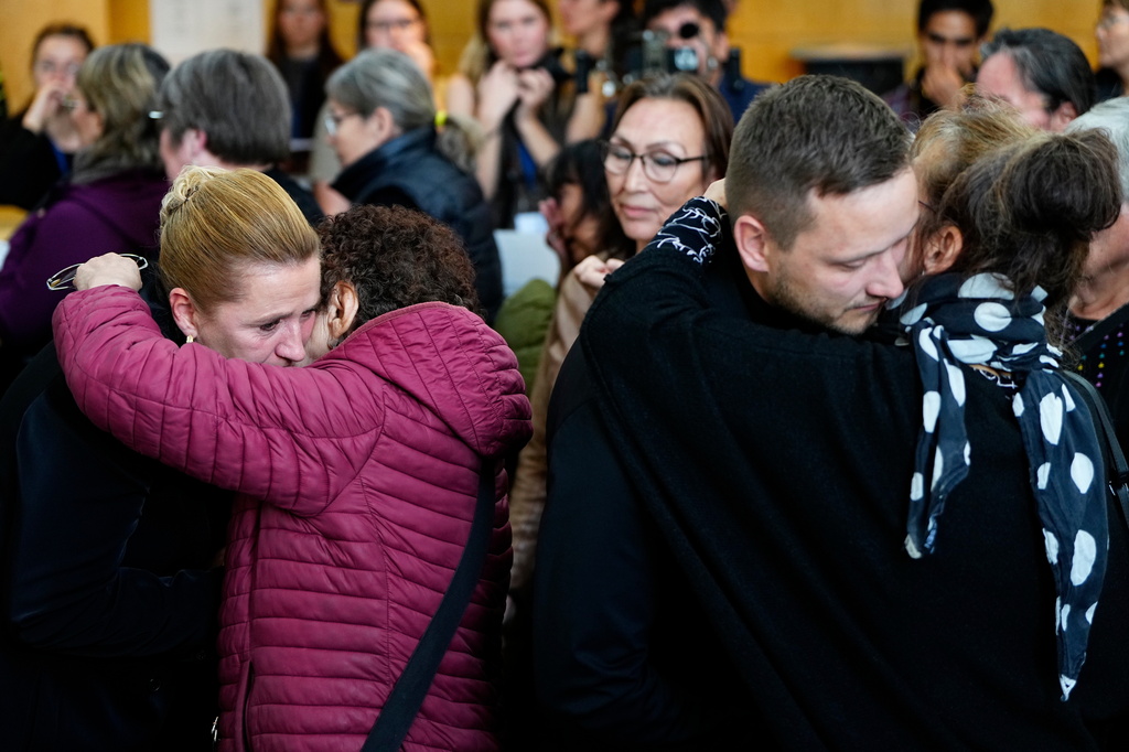 Greenland's Prime Minister Jens-Frederik Nielsen, and Danish Prime Minister Mette Frederiksen, left, greet and apologize to the affected women after a meeting in the cultural house Katuaq in Nuuk, Greenland, Wednesday Sept. 24, 2025. (Mads Claus Rasmussen/Ritzau Scanpix via AP)