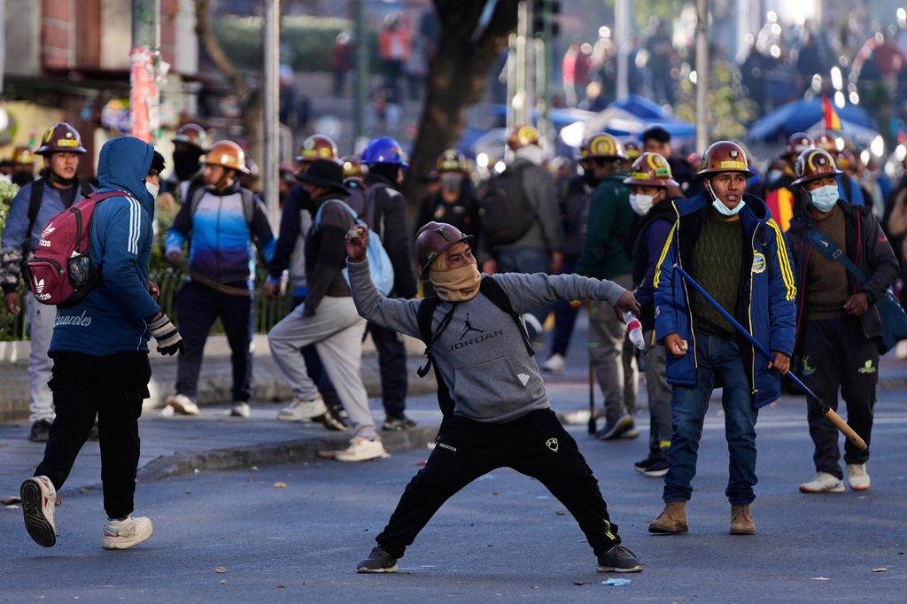 Artisanal miners clash with police during a protest demanding access to expanded mining areas in La Paz, Bolivia, Thursday, May 14, 2026. (AP Photo/Juan Karita)