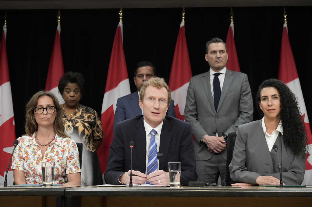 Secretary of State (Children and Youth) Anna Gainey, front left, and MP for Outremont Rachel Bendayan, front right, listen as Canadian Identity and Culture Minister Marc Miller speaks during a news conference in Ottawa, Ontario, Wednesday, June 10, 2026. (Adrian Wyld/The Canadian Press via AP)