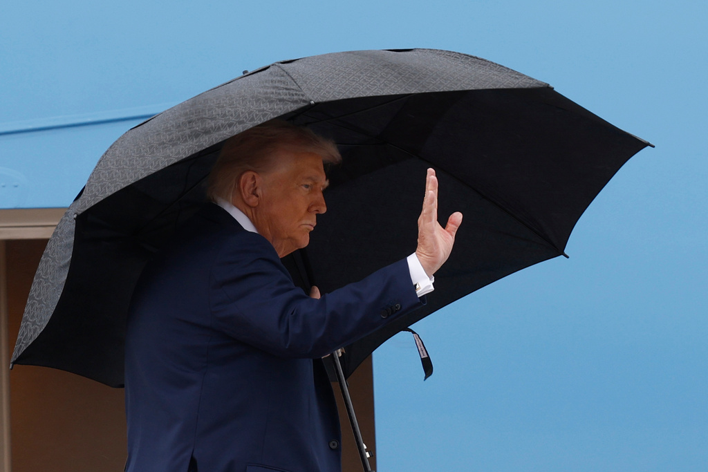 President Donald Trump waves from the stairs of Air Force One as he boards upon his arrival at Joint Base Andrews, Md., Sunday, Oct. 12, 2025, as he travels to the Middle East. (AP Photo/Luis M. Alvarez)