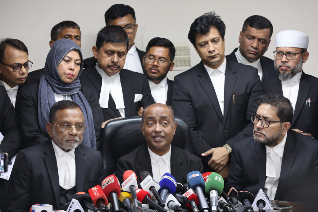 Bangladesh Attorney General Md Asaduzzaman, center sitting, and senior lawyers address a press conference after Supreme Court restored a nonpartisan caretaker government system for national elections but said it won't apply to the polls being held early next year, in Dhaka, Bangladesh, Thursday, Nov. 20, 2025. (AP Photo/Abdul Goni)
