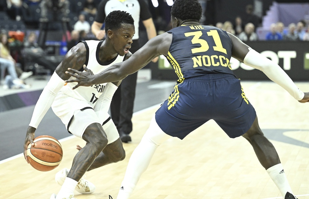 Sweden's Barra Njie, right, and Germany's Dennis Schroeder during Eurobasket, European Basketball Championship group B match between Germany and Sweden in Tampere, Finland, Friday, Aug. 29, 2025. (Heikki Saukkomaa/Lehtikuva via AP)