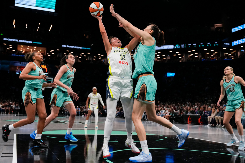Dallas Wings forward Jessica Shepard shoots over New York Liberty center Han Xu during the first half of a WNBA basketball game, Tuesday, July 7, 2026, in New York. (AP Photo/Yuki Iwamura)