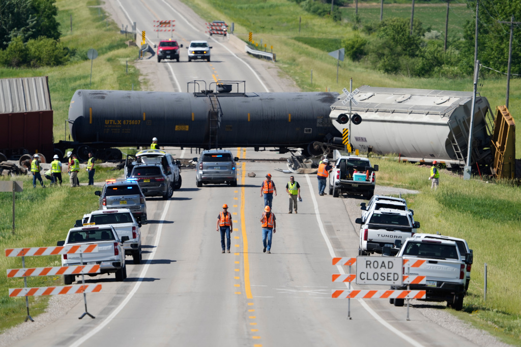 Workers respond after a train derailed on Wednesday, June 3, 2026, near Victor, Iowa. (AP Photo/Charlie Neibergall)